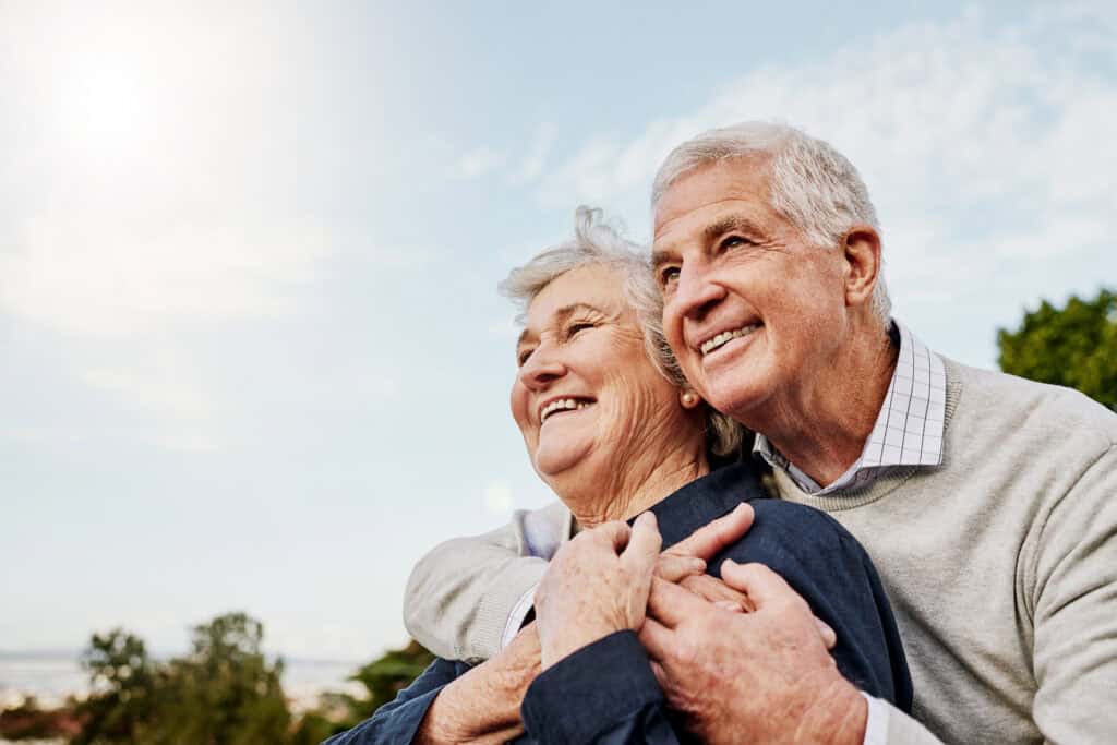 Smiling older couple representing restorative dentistry and tooth restoration in Park City.