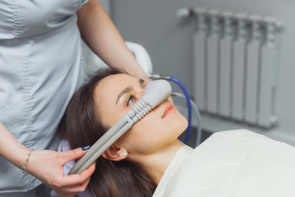 Patient experiencing a relaxed dental visit utilizing nitrous oxide sedation for anxiety relief.